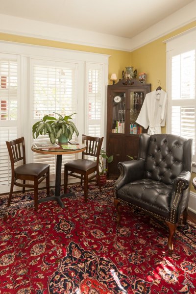 Living room with leather chair and red oriental rug